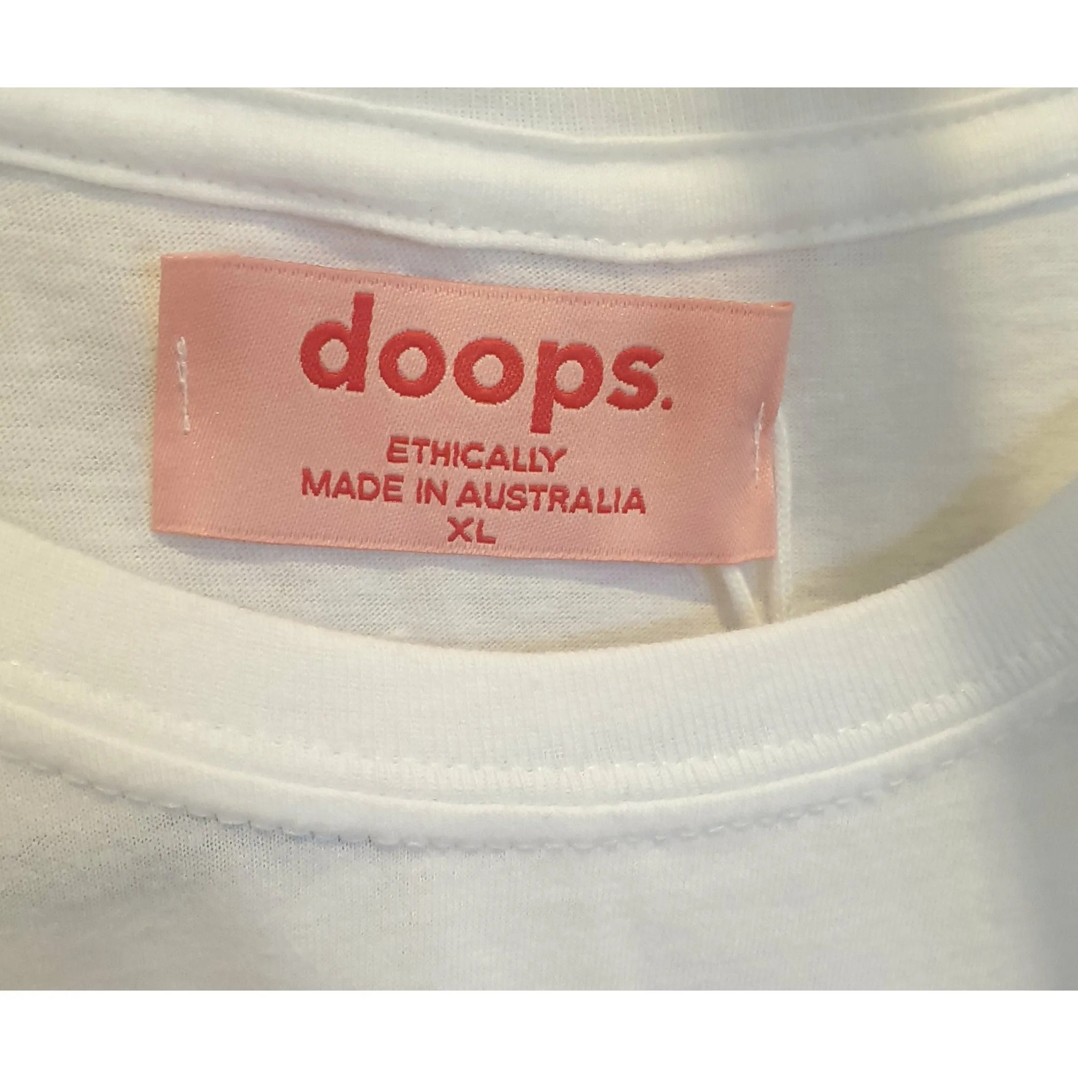 Doops white tee shirt with fun logo size XL (tiny fit, best fits size 12)