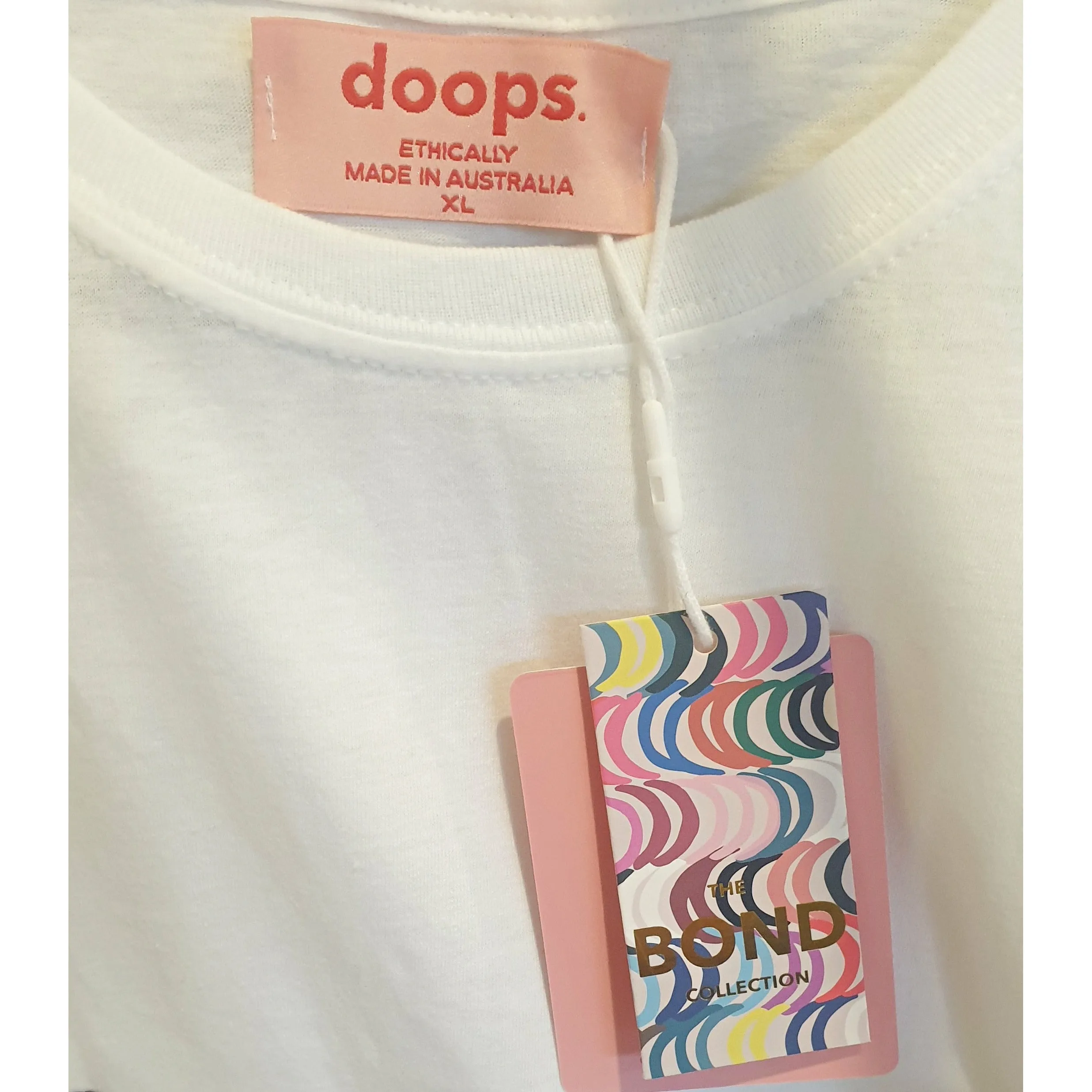 Doops white tee shirt with fun logo size XL (tiny fit, best fits size 12)