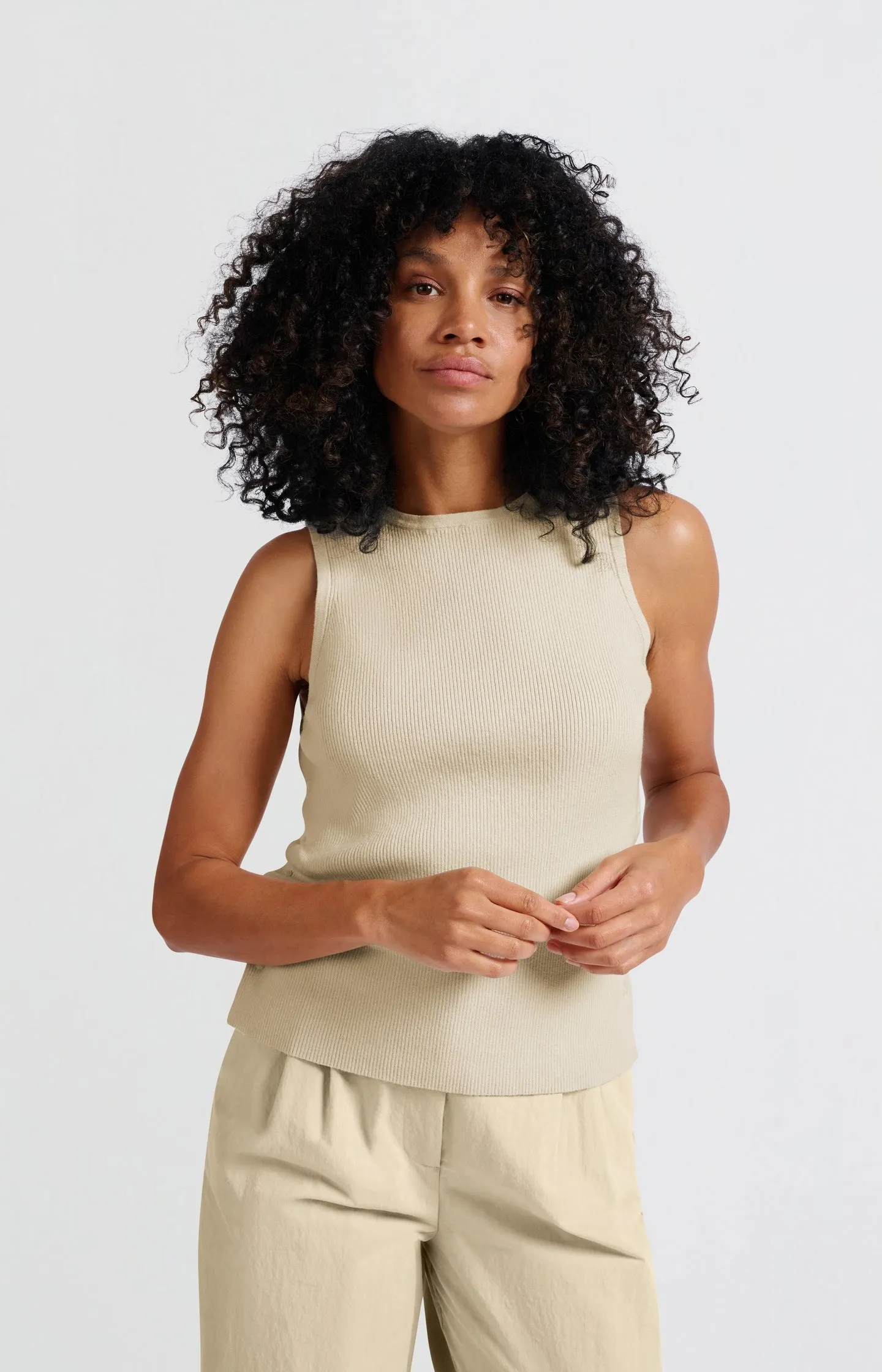 Sleeveless top with side button details and fitted fit